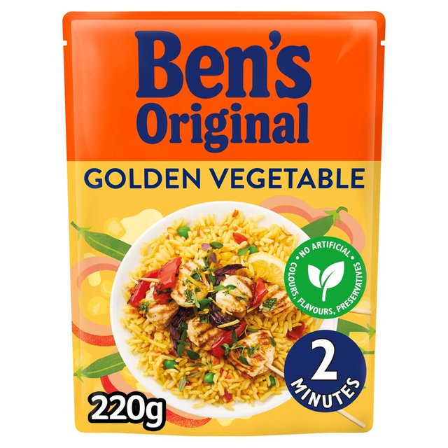 A packet of Uncle Ben’s Microwave Rice Golden Vegetable, 220g. The orange packaging features an image of cooked rice mixed with colorful vegetables. Text on the packet indicates that it contains no artificial colors, flavors, or preservatives and is ready in 2 minutes.