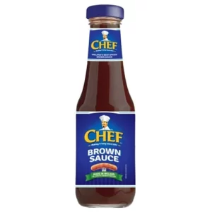 A bottle of Chef—a culinary delight. The bottle has a blue label featuring a logo of a chef wearing a white hat. The label reads "CHEF" in yellow capital letters and "BROWN SAUCE" below, proudly indicating it’s made in Ireland. The cap is also blue, perfect for all your cooking needs.